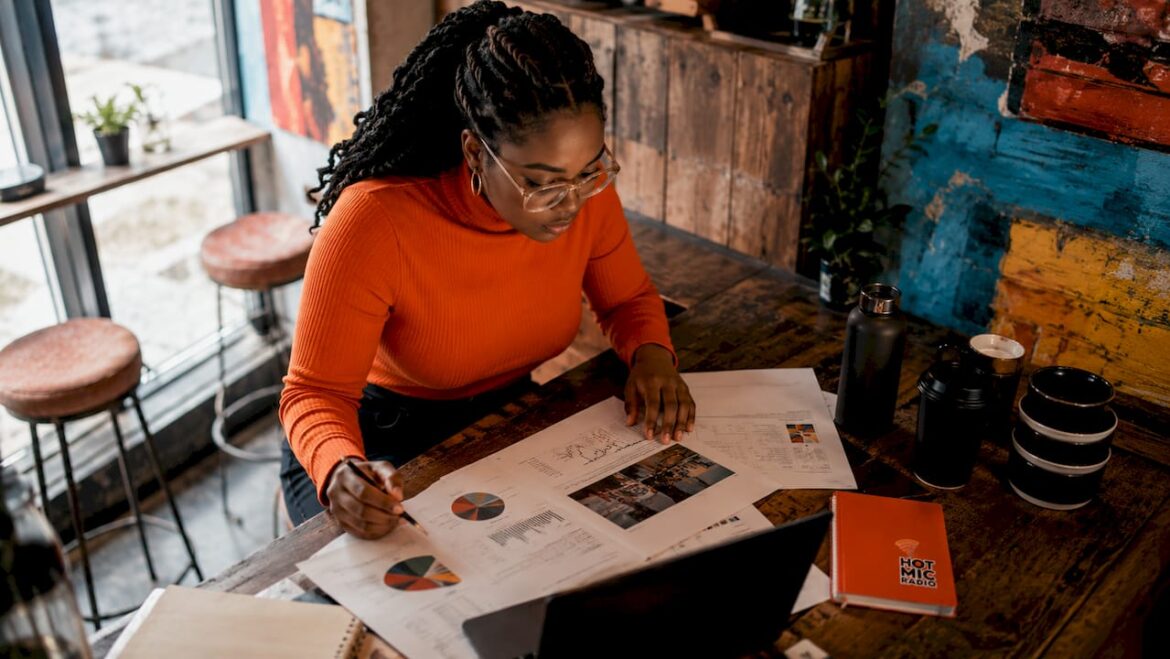 Female music marketer working on campaign at home desk