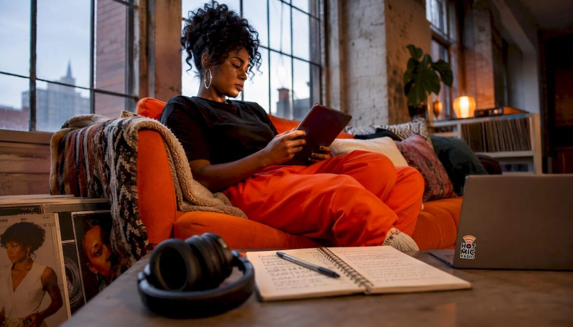 Woman creating R&B playlist on tablet at home