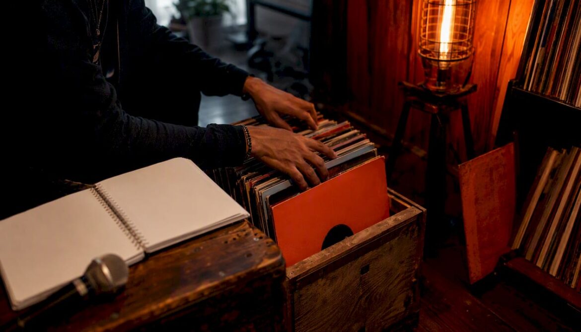 Hands organizing music release materials