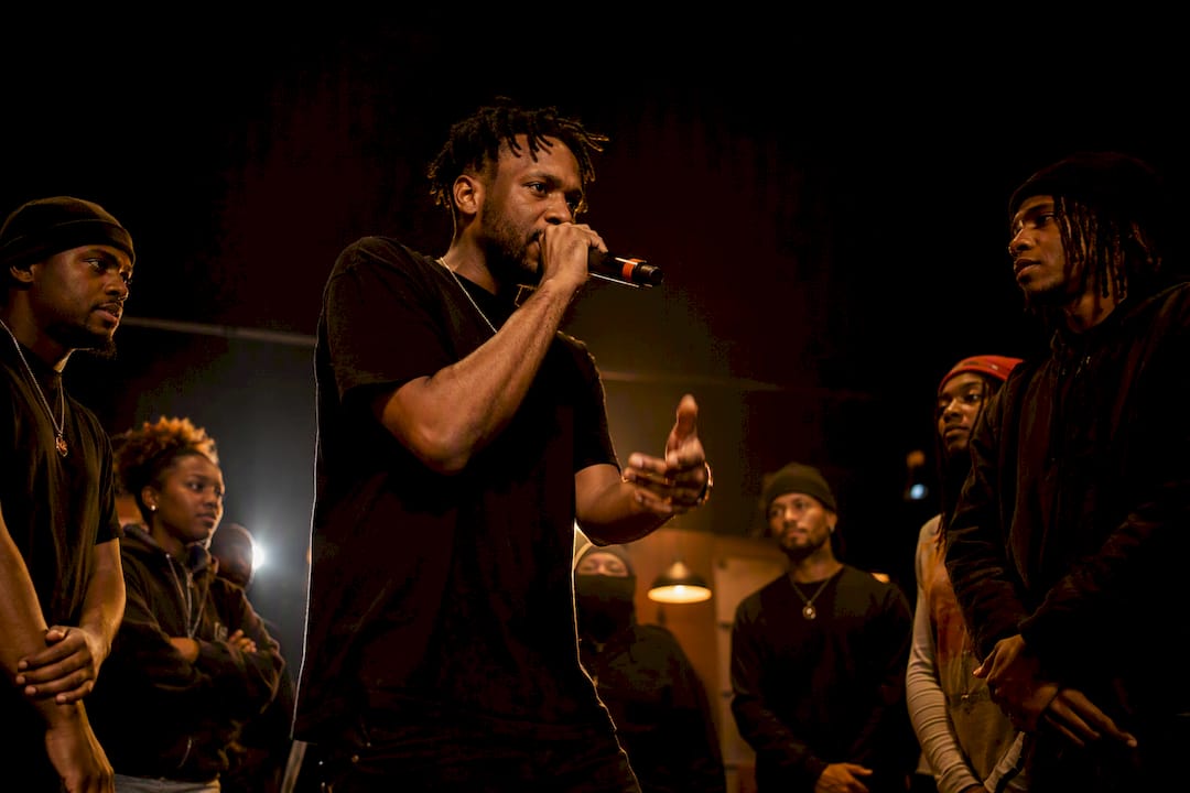 MC performing freestyle in a cypher circle